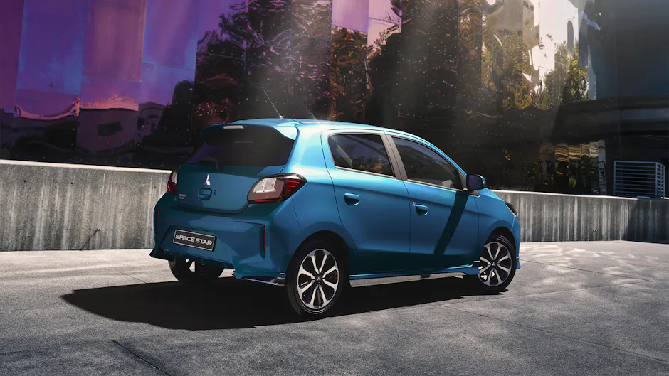 Mitsubishi Space Star bleue, de derrière à droite, en ville