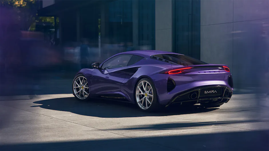 Lotus Emira Turbo mit charakteristischen gelb-schwarzen Lotus-Emblemen von hinten