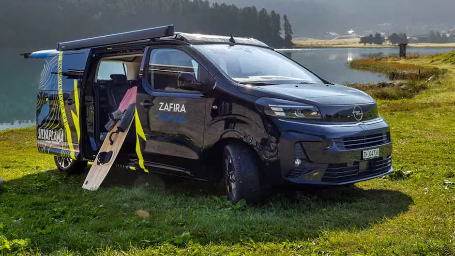 Opel Zafira nero con adesivo Silvaplana, parcheggiato su un prato, porta scorrevole aperta