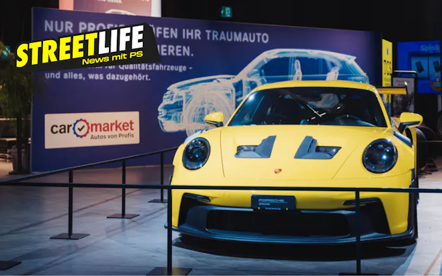 Porsche 911 GT3 RS gialla allo stand Carmarket con il logo Streetlife.