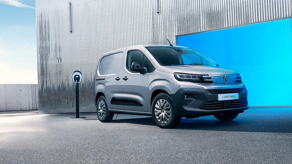 Bus Peugeot bleu à une station de recharge