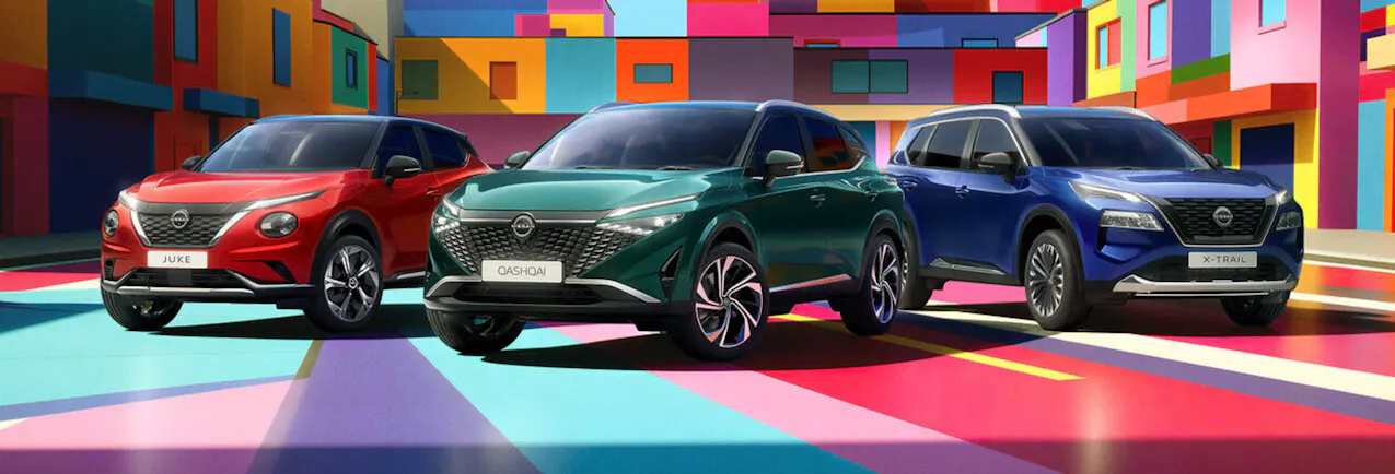 Tre modelli Nissan, con case moderne e colorate sullo sfondo
