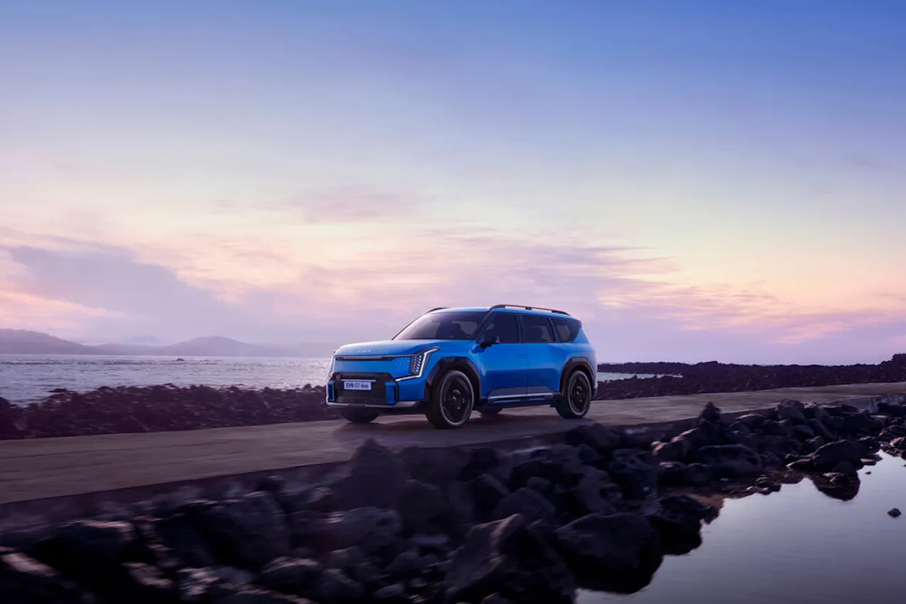 Kia EV9 GT-Line in Blau, während der Fahrt, das Meer im Hintergrund